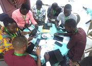 Group of public librarians with tablets, sitting around a table, during a workshop.