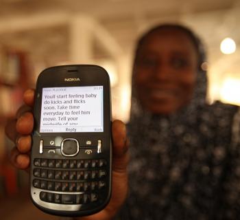 A pregnant woman at Northern Regional Library in Ghana shows her mobile phones, where she receives health information. A pregnant woman at Northern Regional Library in Ghana shows her mobile phones, where she receives health information.