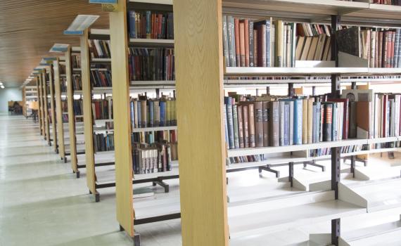 rows of book shelves in a library 