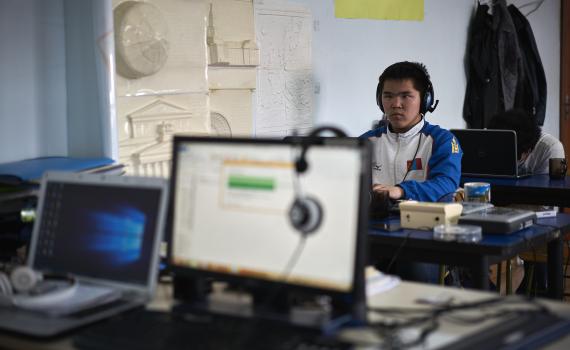 A person with print disability working at a computer.