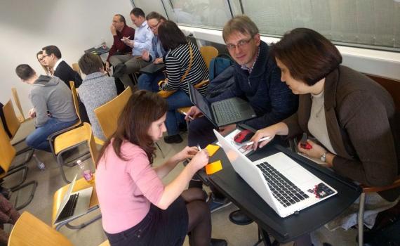 People sitting and working in groups open science trainer bootcamp in Debrecen, Hungary.